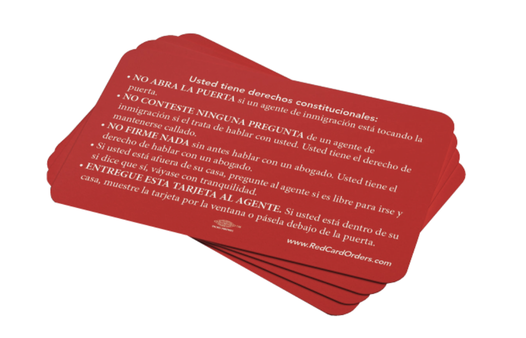 Stack of small, wallet-sized red cards that have instructions printed in Spanish for what to do if you are approached by ICE officials