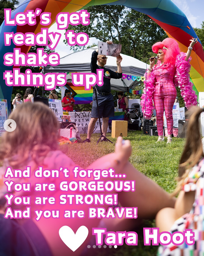 Photo from a drag storytime outdoors in Petworth, DC, showing Tara Hoot reading from a picture book that another person holds up. Tara wears hot pink and has their hair in a huge pink bouffant 'do/wig. Text over the image reads "Let’s get ready to shake things up! And don’t forget…You are GORGEOUS! You are STRONG! And you are BRAVE! <3 Tara Hoot"